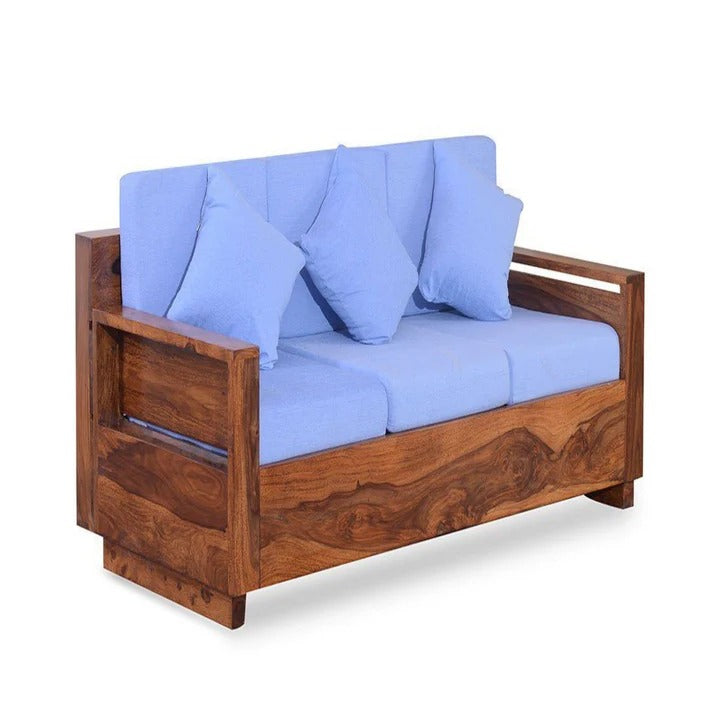 Honey wood single seater sofa chair with blue seat cushions and multiple back pillows