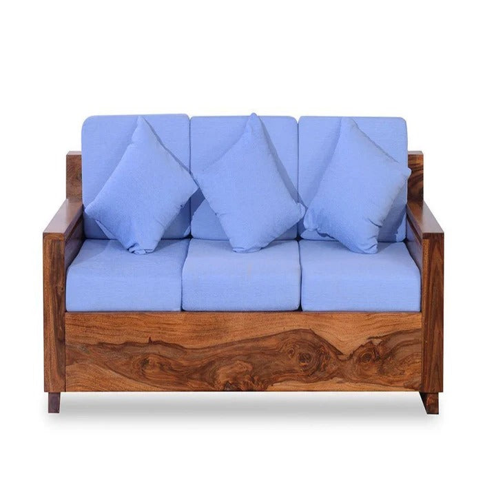 Honey wood single seater sofa chair with blue seat cushions and back pillows