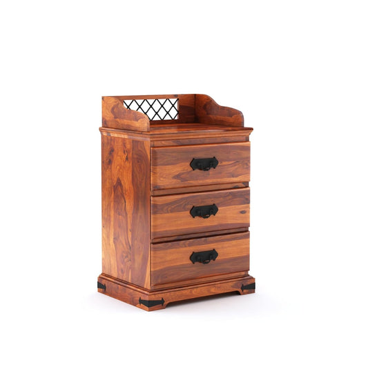 Wooden bedside table with 3 drawers, black handles, and open top tray in warm honey finish.