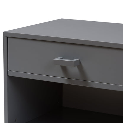 Grey bedside table with a single drawer and open shelf, with metal pull handle.